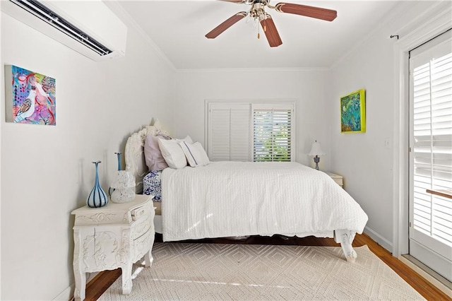 401 Peachtree Battle Ave NW, Atlanta, GA 30305 - bedroom featuring a wall mounted AC, crown molding, wood finished floors, a ceiling fan, and baseboards
