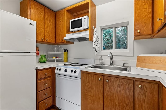 401 Peachtree Battle Ave NW, Atlanta, GA 30305 - kitchen featuring white appliances, under cabinet range hood, a sink, light countertops, and brown cabinets