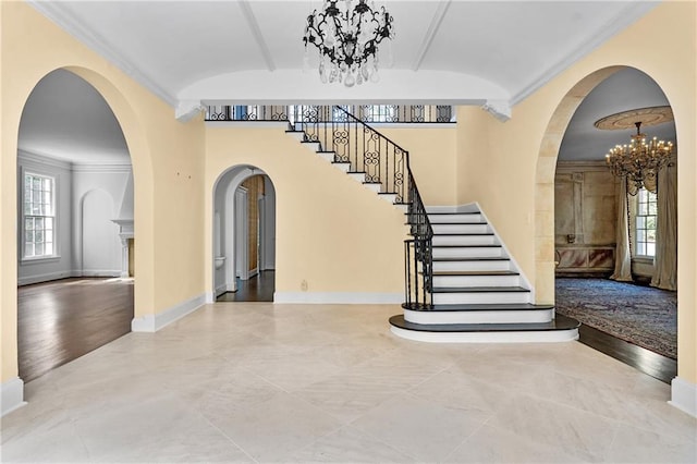 401 Peachtree Battle Ave NW, Atlanta, GA 30305 - entryway featuring a chandelier, stairway, ornamental molding, baseboards, and arched walkways