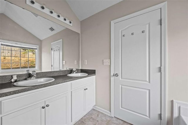 bathroom featuring vanity and lofted ceiling