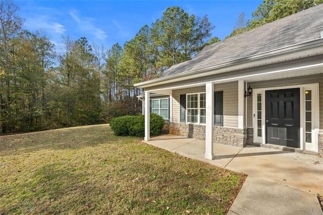 exterior space with covered porch and a yard