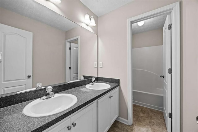 bathroom with vanity and a textured ceiling