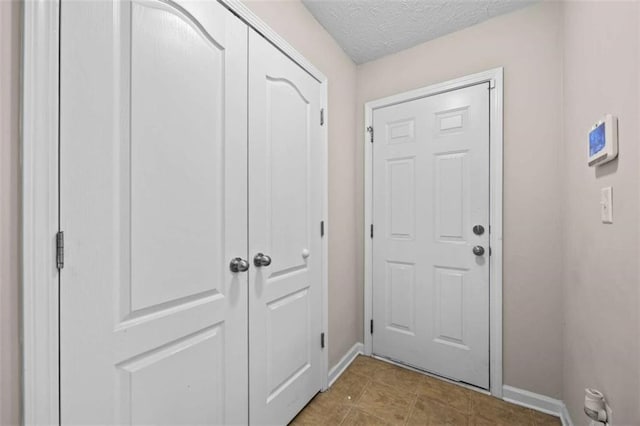 doorway with a textured ceiling