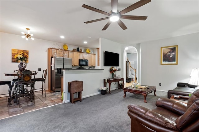 living area with ceiling fan, arched walkways, stairway, light carpet, and recessed lighting