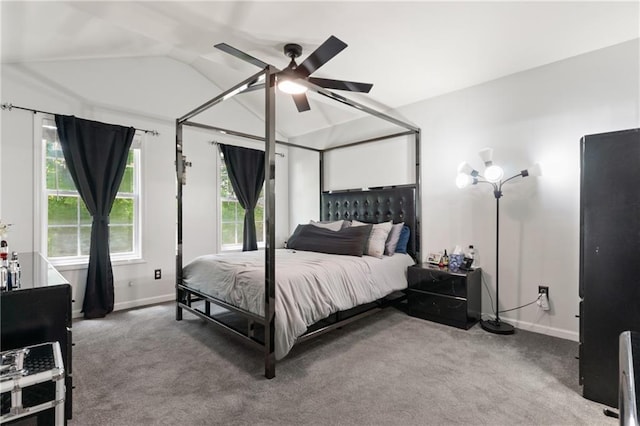 carpeted bedroom with a ceiling fan, baseboards, and vaulted ceiling