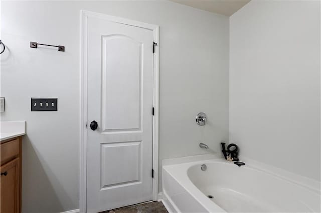 bathroom featuring a tub to relax in and vanity