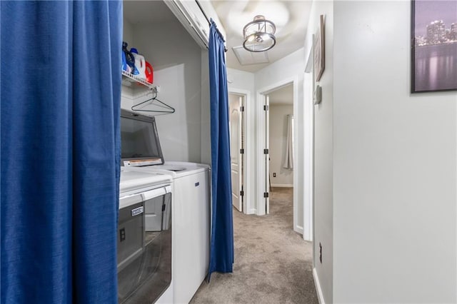 washroom with independent washer and dryer, laundry area, light colored carpet, and baseboards