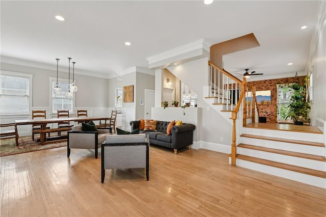 218 S Ave SE, Atlanta, GA 30315 - living room featuring stairs, healthy amount of natural light, light wood-style flooring, a wainscoted wall, and crown molding