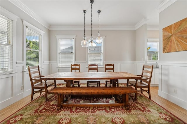 218 S Ave SE, Atlanta, GA 30315 - dining space with healthy amount of natural light, light wood-type flooring, a wainscoted wall, crown molding, and a decorative wall