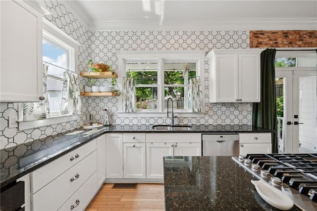 218 S Ave SE, Atlanta, GA 30315 - kitchen featuring a sink, ornamental molding, stainless steel appliances, white cabinets, and decorative backsplash