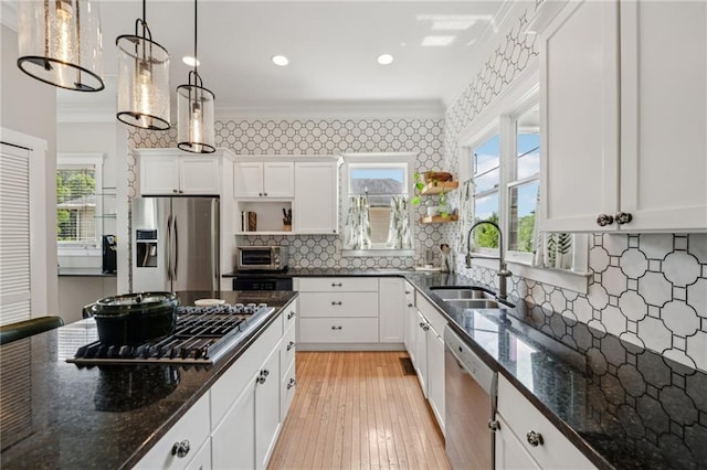 218 S Ave SE, Atlanta, GA 30315 - kitchen with stainless steel appliances, a sink, open shelves, ornamental molding, and white cabinets