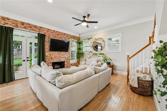 218 S Ave SE, Atlanta, GA 30315 - living room featuring a ceiling fan, light wood finished floors, baseboards, stairway, and a brick fireplace