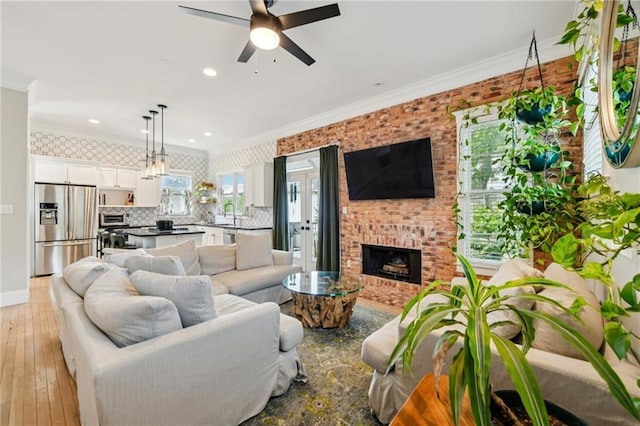 218 S Ave SE, Atlanta, GA 30315 - living area featuring ornamental molding, ceiling fan, light wood-style floors, a fireplace, and recessed lighting