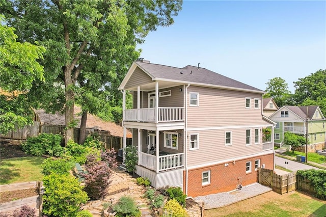 218 S Ave SE, Atlanta, GA 30315 - back of property featuring a balcony, a fenced backyard, and brick siding