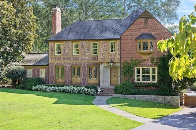 tudor house featuring a front lawn