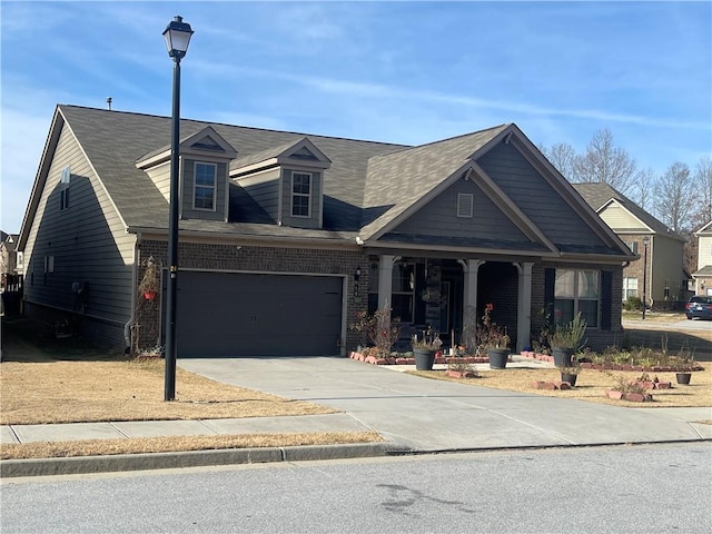 view of front facade featuring covered porch and a garage