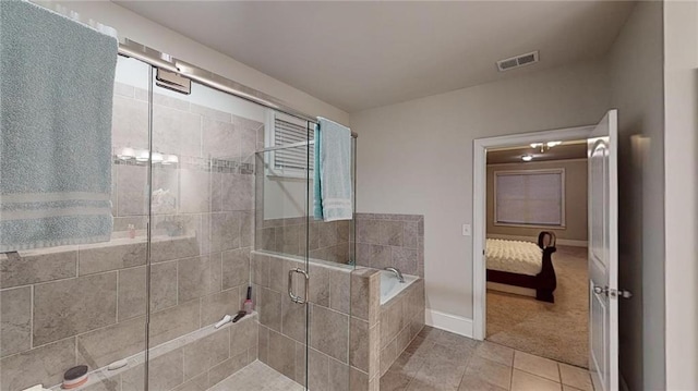 bathroom featuring tile patterned floors and separate shower and tub