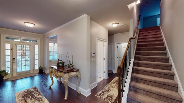 foyer entrance featuring dark wood-type flooring and ornamental molding