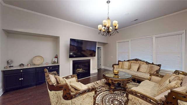 living room with dark hardwood / wood-style flooring, a chandelier, and ornamental molding