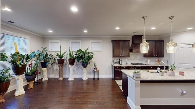 kitchen with ornamental molding, custom range hood, sink, decorative light fixtures, and dark hardwood / wood-style floors