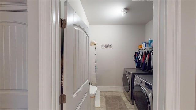 laundry area featuring washer and clothes dryer and light tile patterned floors