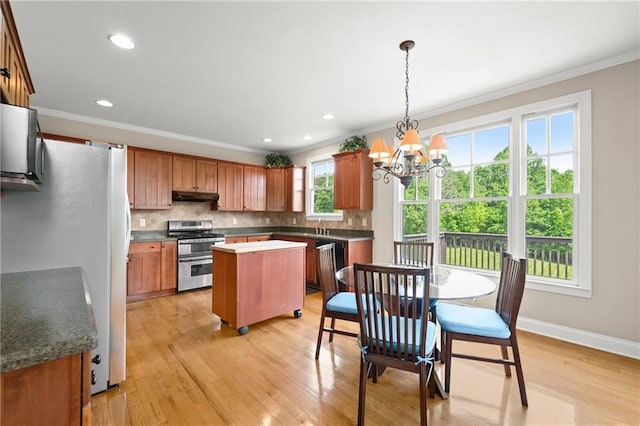 541 Brown Dr, Clermont, GA 30527 - kitchen featuring range with two ovens, freestanding refrigerator, under cabinet range hood, a chandelier, and a kitchen island