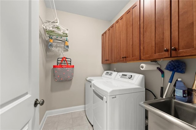 541 Brown Dr, Clermont, GA 30527 - laundry area featuring washing machine and clothes dryer, cabinet space, baseboards, and light tile patterned flooring