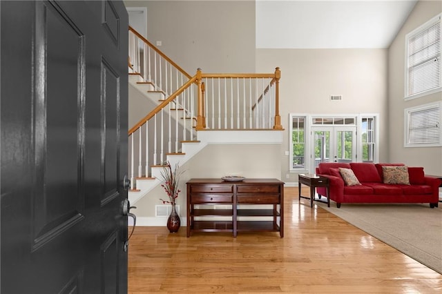 541 Brown Dr, Clermont, GA 30527 - entrance foyer featuring high vaulted ceiling, light wood finished floors, stairway, and baseboards