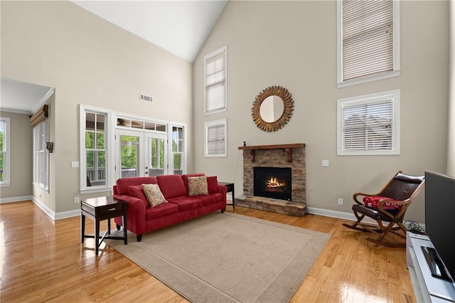 541 Brown Dr, Clermont, GA 30527 - living area with high vaulted ceiling, light wood-type flooring, baseboards, french doors, and a fireplace