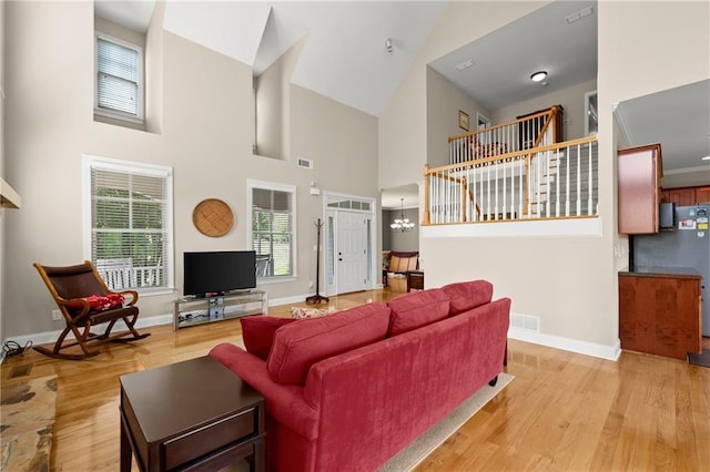 541 Brown Dr, Clermont, GA 30527 - living room featuring light wood-style floors, a high ceiling, and baseboards