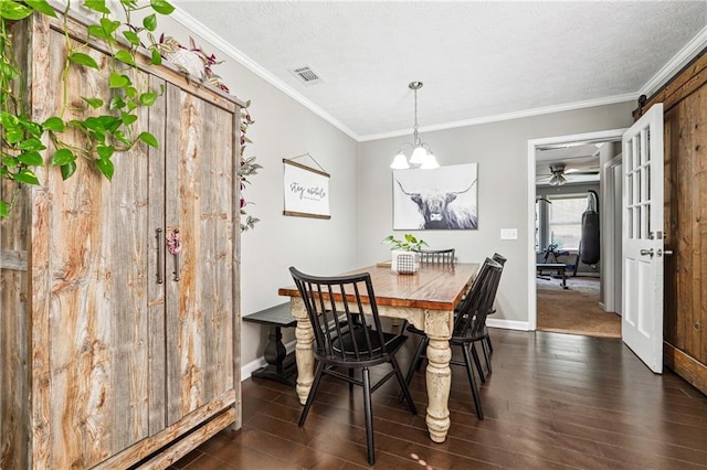 dining room featuring visible vents, a textured ceiling, dark wood finished floors, and crown molding