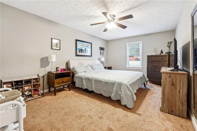 carpeted bedroom with a textured ceiling and ceiling fan