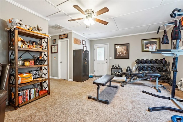 exercise room featuring ornamental molding, visible vents, carpet floors, and ceiling fan