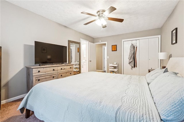 bedroom featuring baseboards, carpet floors, a closet, a textured ceiling, and a ceiling fan