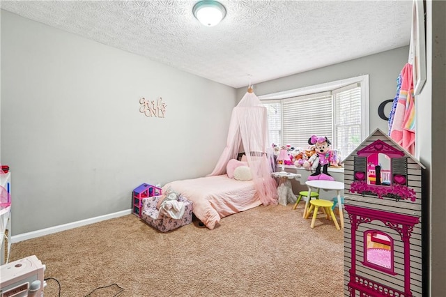 carpeted bedroom with a textured ceiling and baseboards