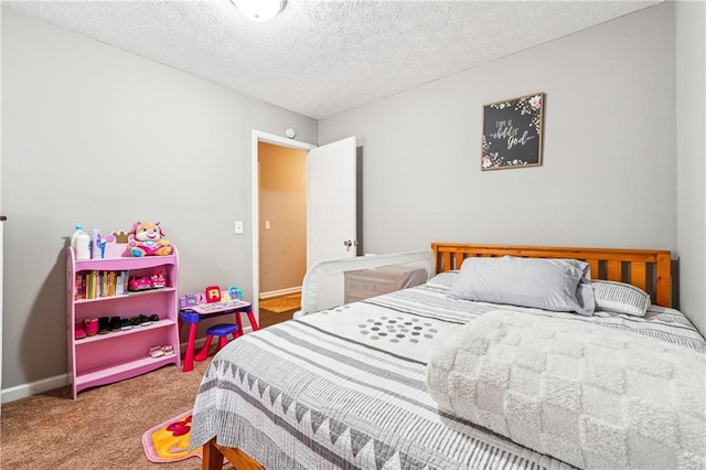 carpeted bedroom with baseboards and a textured ceiling