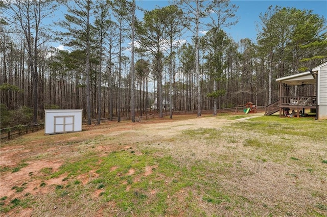 view of yard featuring a shed, fence private yard, and an outdoor structure