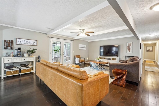 living room with visible vents, wood-type flooring, a textured ceiling, and beam ceiling