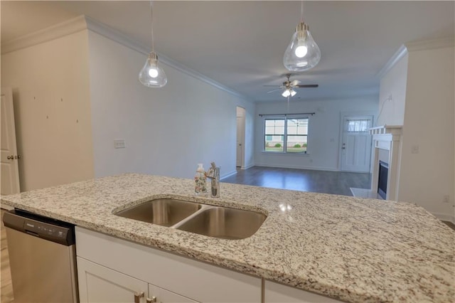2929 Rambler Dr, Loganville, GA 30052 - kitchen featuring dishwasher, a sink, decorative light fixtures, light stone counters, and crown molding