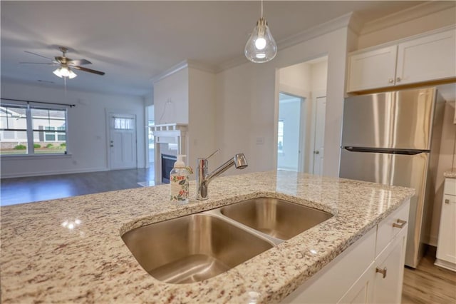 2929 Rambler Dr, Loganville, GA 30052 - kitchen with freestanding refrigerator, a sink, light wood-type flooring, white cabinets, and ceiling fan
