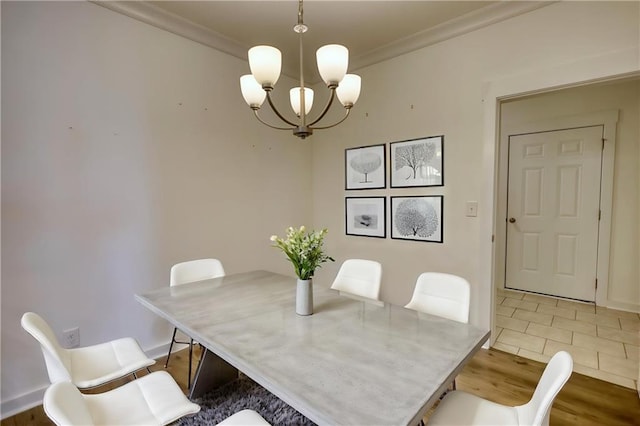 2929 Rambler Dr, Loganville, GA 30052 - dining room featuring a chandelier, ornamental molding, light wood finished floors, and baseboards