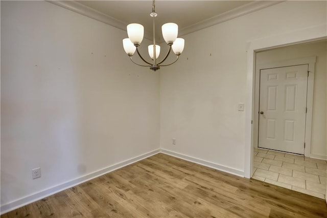 2929 Rambler Dr, Loganville, GA 30052 - unfurnished dining area featuring crown molding, a chandelier, wood finished floors, and baseboards
