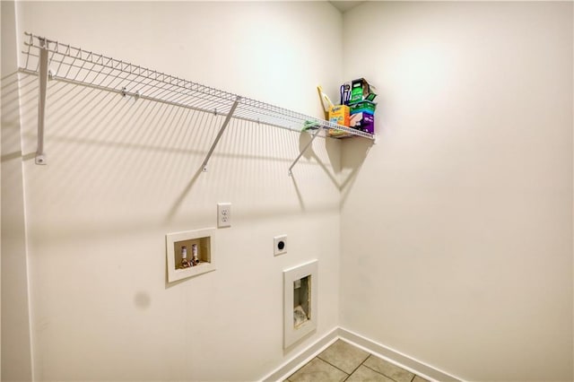 2929 Rambler Dr, Loganville, GA 30052 - washroom with electric dryer hookup, washer hookup, tile patterned flooring, and baseboards