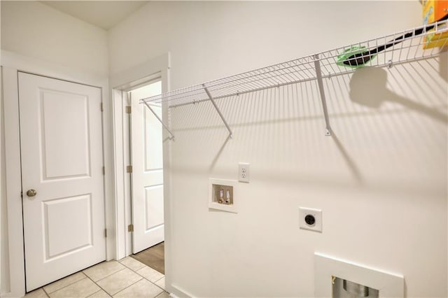 2929 Rambler Dr, Loganville, GA 30052 - laundry area with hookup for a washing machine, electric dryer hookup, and light tile patterned flooring