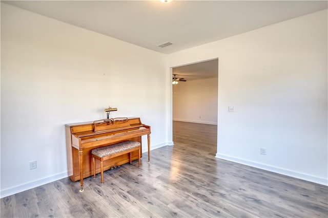 2929 Rambler Dr, Loganville, GA 30052 - sitting room with wood finished floors, baseboards, and ceiling fan