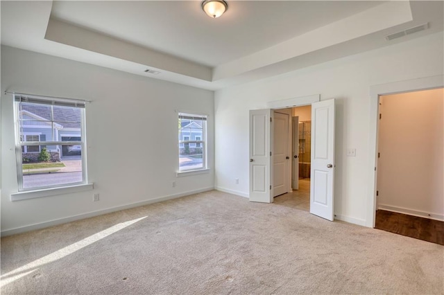 2929 Rambler Dr, Loganville, GA 30052 - unfurnished bedroom with carpet floors, a tray ceiling, and baseboards