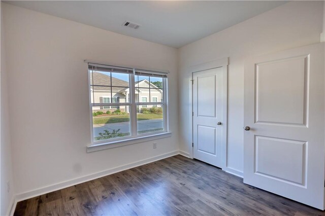 2929 Rambler Dr, Loganville, GA 30052 - unfurnished bedroom featuring dark wood-type flooring and baseboards