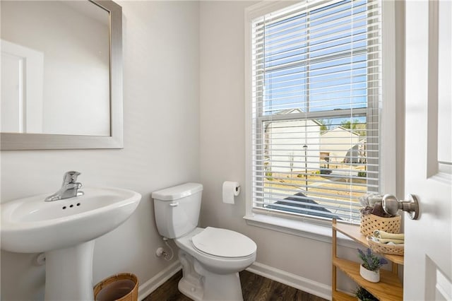 bathroom featuring toilet, wood finished floors, and baseboards
