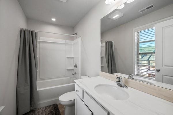 full bathroom featuring vanity, visible vents, recessed lighting, toilet, and washtub / shower combination