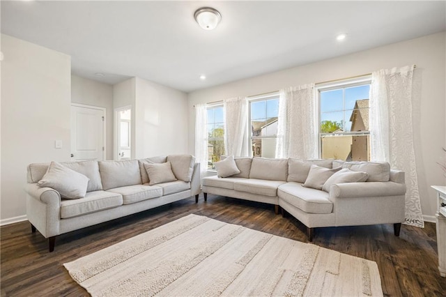 living room with dark wood-type flooring, baseboards, and recessed lighting
